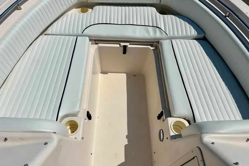 Slide: The Image of 2006 Grady White 225 Dual Console boat interior with cushioned seating and cup holders. - 14