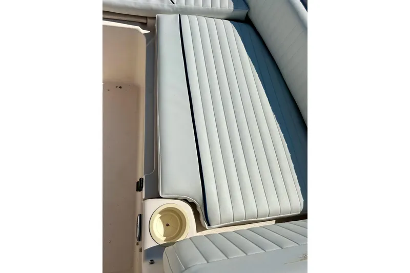 Slide: The Image of 2006 Grady White 225 Dual Console boat interior with cushioned seating and cup holder. - 16