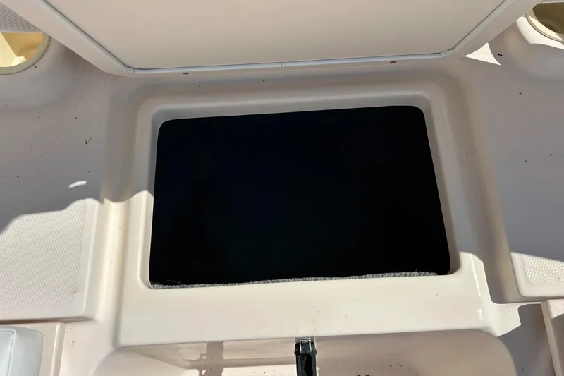 Slide: The Image of Open storage compartment on a 2006 Grady White 225 Dual Console boat. - 19