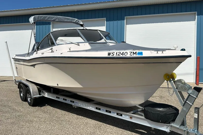 Slide: The Image of 2006 Grady White 225 Dual Console boat on trailer, parked outdoors. - 2