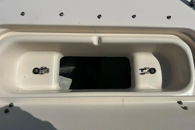 Slide: The Image of Grady White 225 Dual Console 2006 boat compartment with open hatch and visible fasteners. - 21