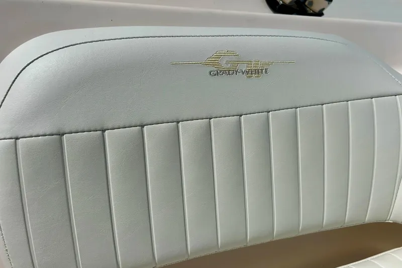 Slide: The Image of Grady White 225 Dual Console 2006 boat seat with logo, white upholstery. - 23