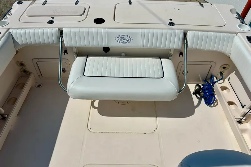 Slide: The Image of 2006 Grady White 225 Dual Console boat interior with foldable seating and storage compartments. - 24