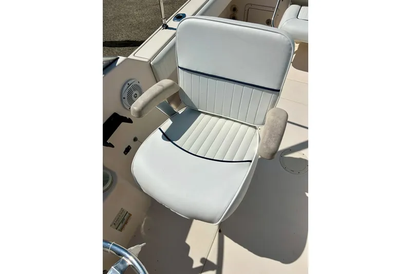 Slide: The Image of Captain's chair on 2006 Grady White 225 Dual Console boat, featuring white upholstery and armrests. - 26
