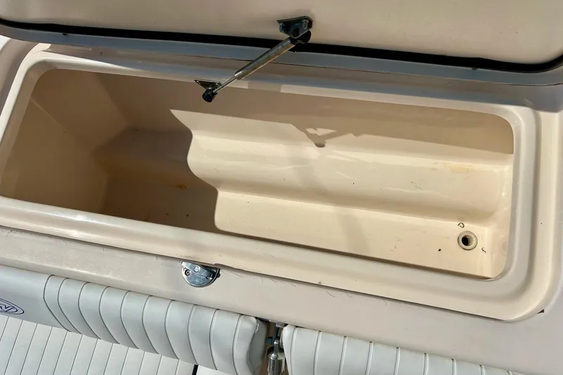 Slide: The Image of Open storage compartment on 2006 Grady White 225 Dual Console boat. - 32