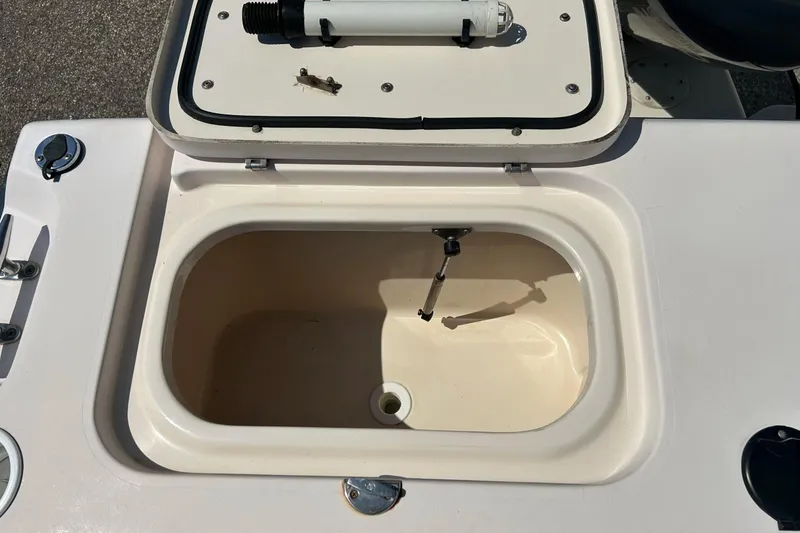 Slide: The Image of Open storage compartment on a 2006 Grady White 225 Dual Console boat. - 34