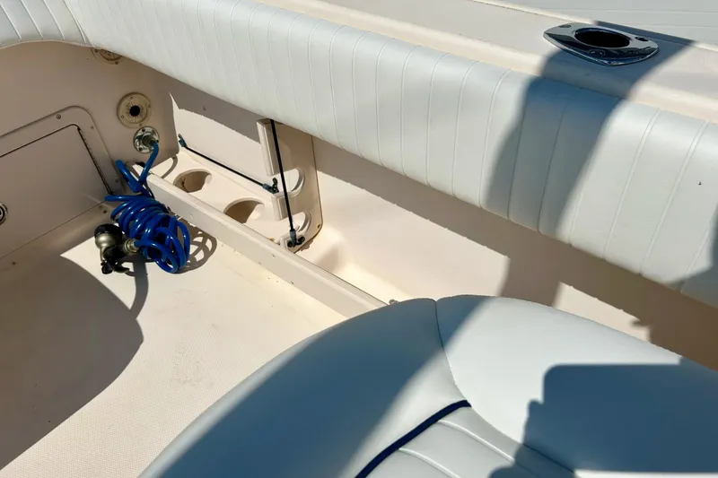 Slide: The Image of 2006 Grady White 225 Dual Console boat interior with seating and coiled blue hose. - 41