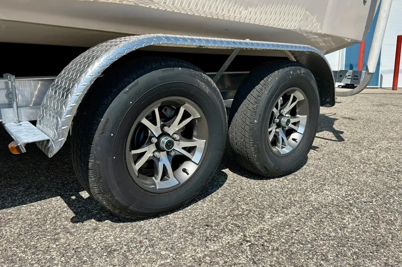 Slide: The Image of Trailer wheels of a 2006 Grady White 225 Dual Console boat. - 48