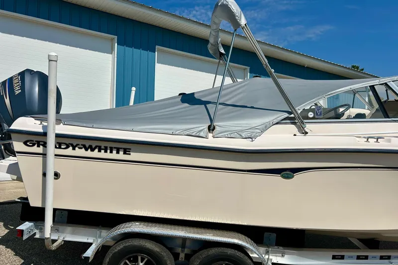 Slide: The Image of 2006 Grady White 225 Dual Console boat on trailer, covered, with Yamaha engine. - 5