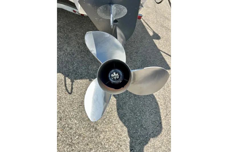 Slide: The Image of Propeller of 2006 Grady White 225 Dual Console boat on pavement background. - 50