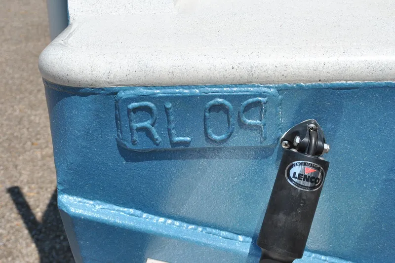 Slide: The Image of Blue boat hull with "RL09" marking and Lenco Marine actuator, Custom 24, 2009 model. - 11
