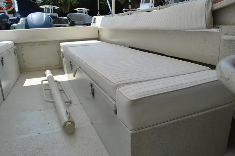 Slide: The Image of Interior of a 2009 Custom 24 boat with cushioned seating and storage compartments. - 18