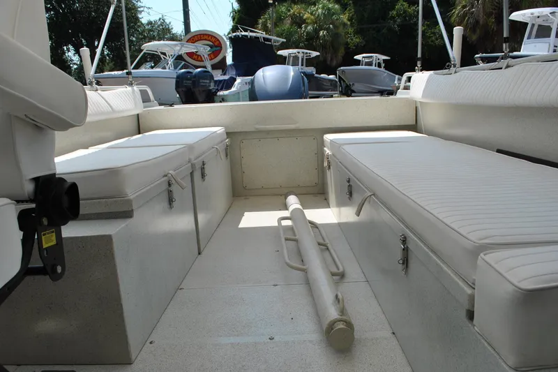 Slide: The Image of Interior view of a 2009 Custom 24 boat with seating and storage compartments. - 19