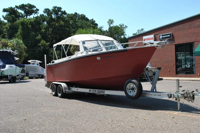 Slide: The Image of Red Custom 24 boat on trailer, parked outside Yamaha dealership, 2009 model. - 4