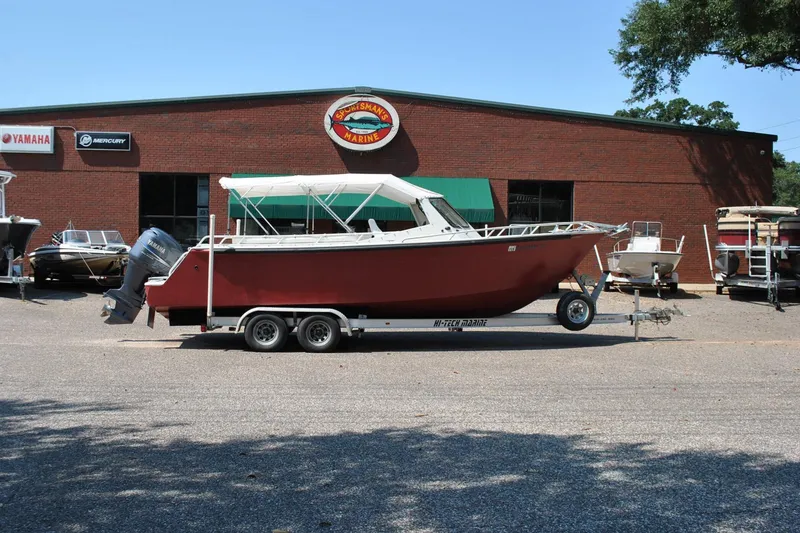 Slide: The Image of Red custom boat on trailer outside Sportsman's Marine dealership, 2009 model. - 5