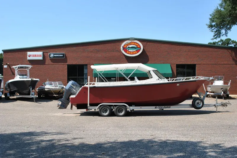 Slide: The Image of Custom 24 boat from 2009 on trailer outside marine dealership. - 6