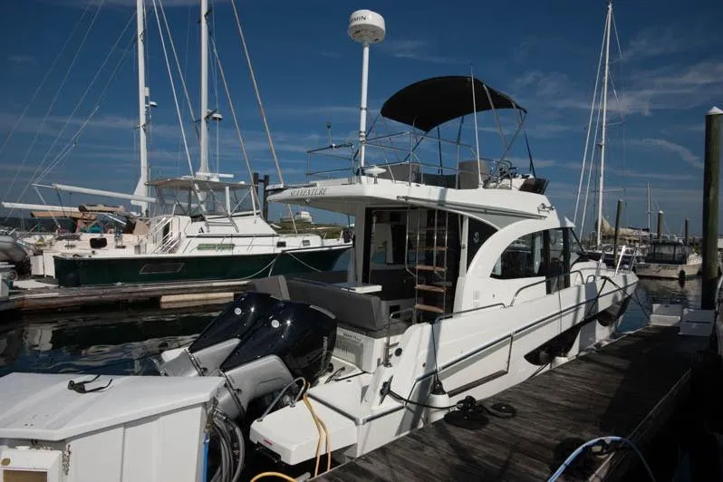 Slide: The Image of 2024 Beneteau Antares 11 Fly at marina, featuring twin 300 V8 engines. - 3