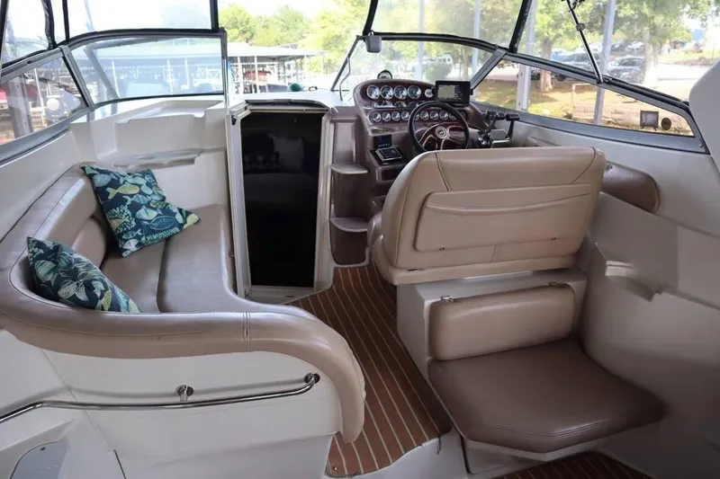 Slide: The Image of Interior of 2002 Regal Commodore 2860 boat with seating and control panel. - 10