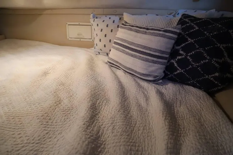 Slide: The Image of Cozy cabin bed with patterned pillows in 2002 Regal Commodore 2860 boat. - 12