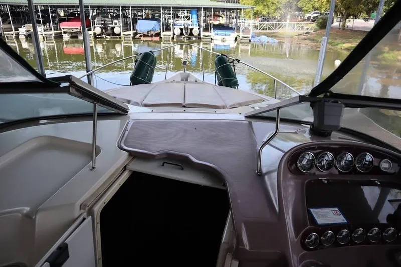 Slide: The Image of 2002 Regal Commodore 2860 boat interior with dashboard and marina view. - 15