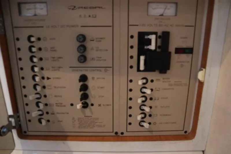 Slide: The Image of Control panel of a 2002 Regal Commodore 2860 boat, featuring various switches and gauges. - 16