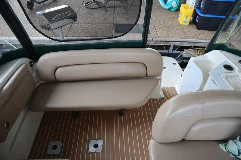 Slide: The Image of Interior of 2002 Regal Commodore 2860 boat with beige seating and wood-patterned flooring. - 8