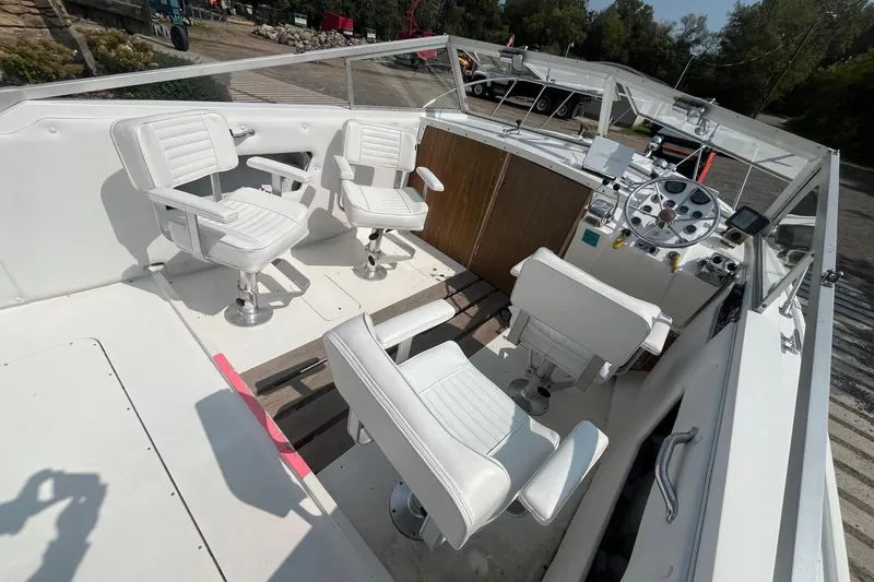 Slide: The Image of 1975 Bertram 26 Moppie boat interior with white seating and control panel. - 11