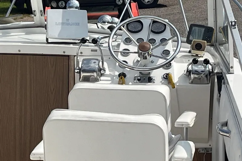 Slide: The Image of 1975 Bertram 26 Moppie boat helm with steering wheel and navigation equipment. - 13