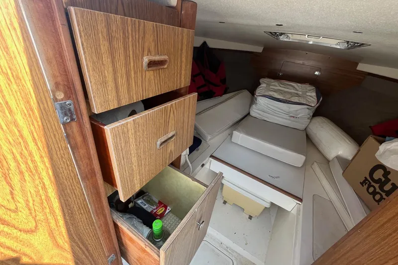 Slide: The Image of Interior of a 1975 Bertram 26 Moppie boat with wooden cabinets and cushions. - 21
