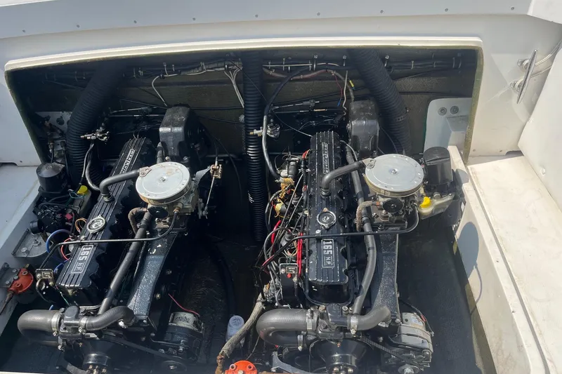 Slide: The Image of Engine compartment of a 1975 Bertram 26 Moppie boat, showcasing dual engines. - 24