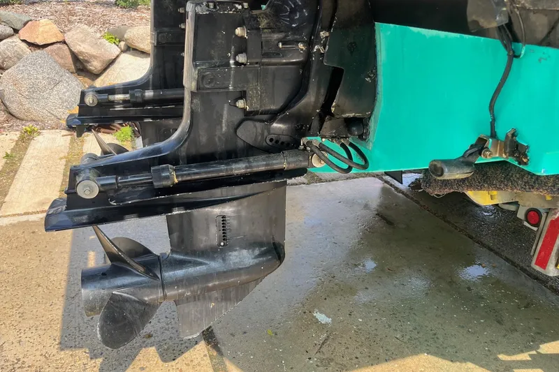 Slide: The Image of Close-up of a 1975 Bertram 26 Moppie boat's outboard motor and propeller. - 4