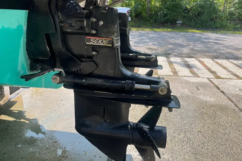 Slide: The Image of 1975 Bertram 26 Moppie boat engine with SE106 outdrive, parked outdoors. - 5