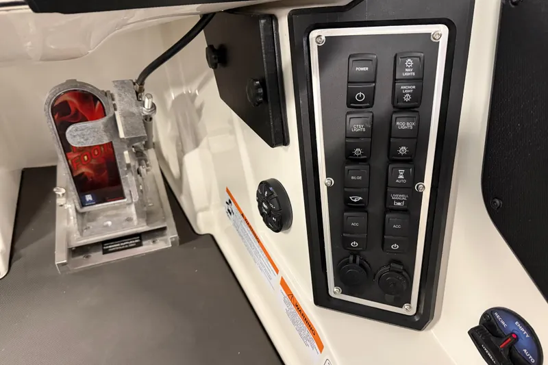 Slide: The Image of 2026 Ranger Z519 boat deck with gray carpeting, displayed in a showroom. - 10