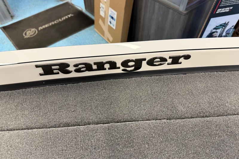 Slide: The Image of 2026 Ranger Z519 boat interior with black textured deck and white seating. - 14