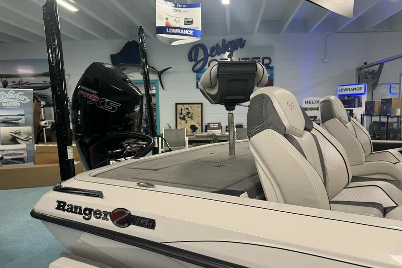 Slide: The Image of 2026 Ranger Z519 boat interior with seating and control panel in a showroom. - 3
