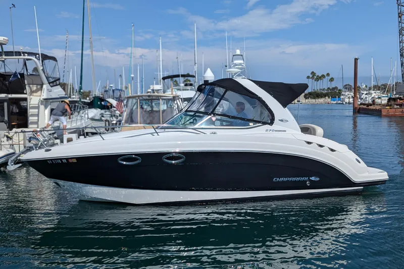The Image of 2011 Chaparral Signature 270 boat in a marina with other yachts. - 0