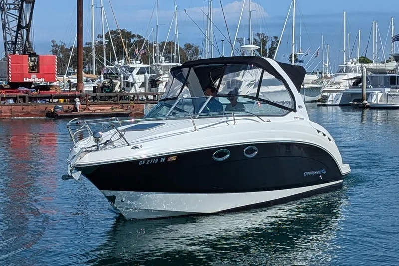 Slide: The Image of 2011 Chaparral Signature 270 boat docked in a marina, clear sky background. - 1