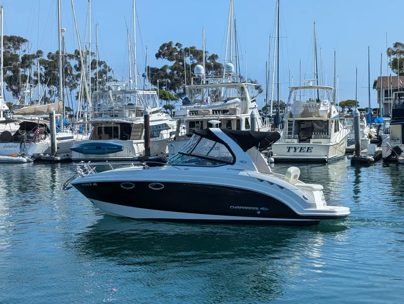 Slide: The Image of 2011 Chaparral Signature 270 boat docked in a marina with other boats. - 10