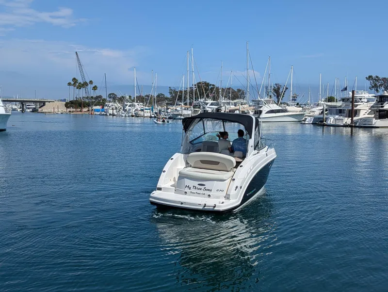 Slide: The Image of 2011 Chaparral Signature 270 boat cruising in a marina. - 17