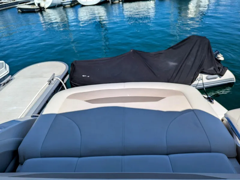 Slide: The Image of 2011 Chaparral Signature 270 boat docked at marina with covered vessel nearby. - 23