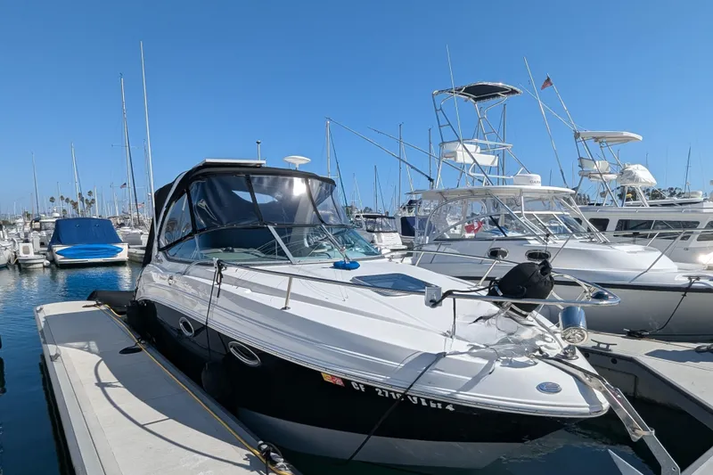 Slide: The Image of 2011 Chaparral Signature 270 boat docked in a marina under clear blue skies. - 45