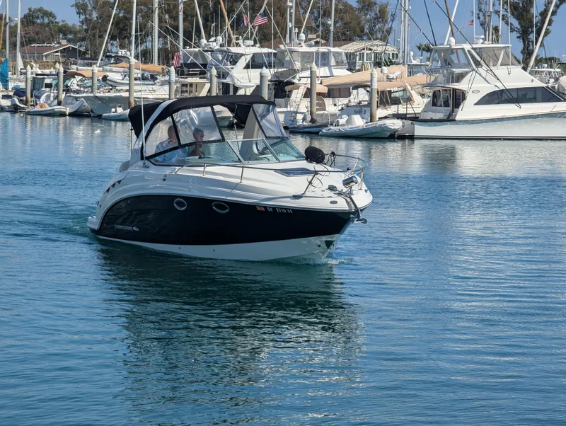 Slide: The Image of 2011 Chaparral Signature 270 boat cruising in a marina with other yachts. - 9