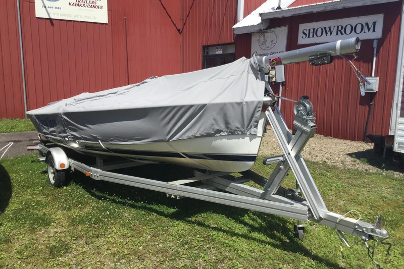 Slide: The Image of Covered 2002 Flying Scot 19 sailboat on trailer outside showroom. - 4