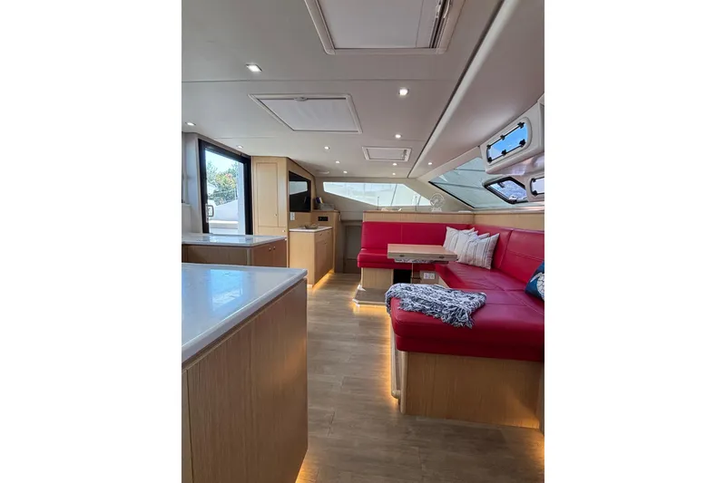 Slide: The Image of Luxurious interior of 2022 Seawind 1600 catamaran with red seating and modern design. - 11