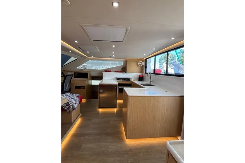Slide: The Image of Luxurious interior of 2022 Seawind 1600 catamaran with modern kitchen and seating area. - 14