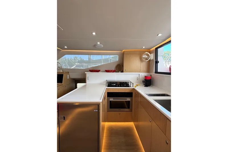 Slide: The Image of Modern kitchen interior of 2022 Seawind 1600 catamaran with sleek design and appliances. - 16