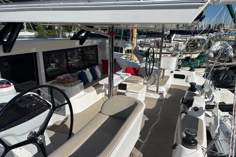 Slide: The Image of Luxurious 2022 Seawind 1600 catamaran interior with modern seating and navigation equipment. - 2