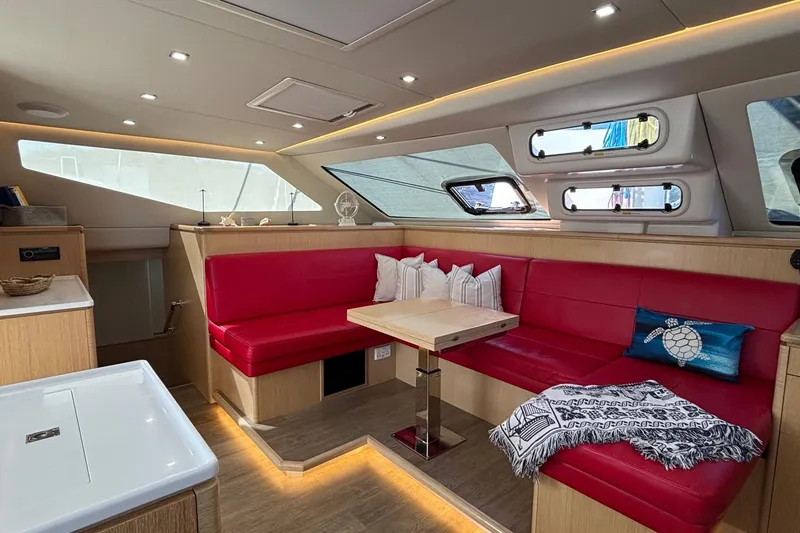 Slide: The Image of Luxurious interior of 2022 Seawind 1600 catamaran with red seating and modern design. - 3