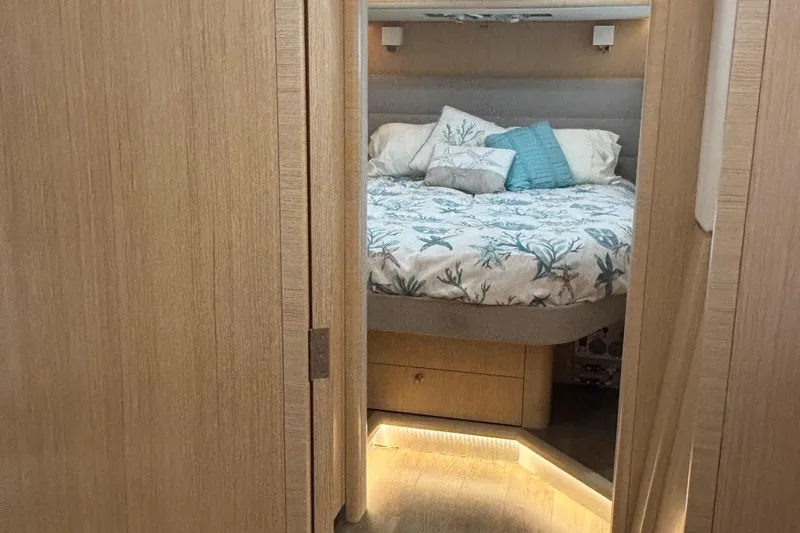 Slide: The Image of Cozy cabin interior of 2022 Seaway 1600 with nautical-themed bedding and soft lighting. - 35