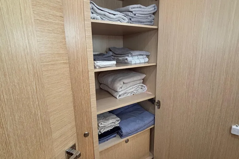 Slide: The Image of Open wooden cabinet with neatly folded towels and linens, Seaway 1600, 2022 model. - 37